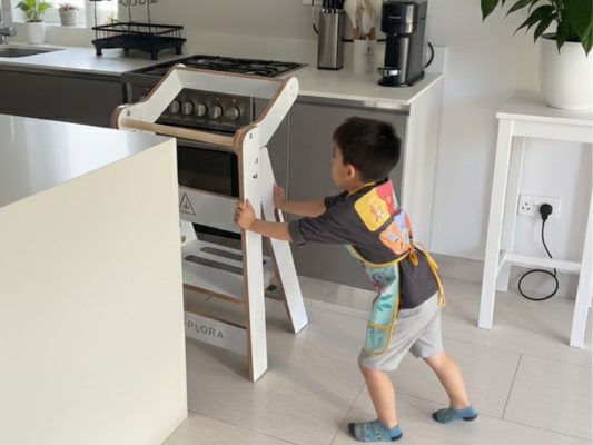 niño empujando con decision torre de aprendizaje zalu antes de subirse